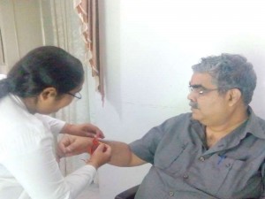 B.K. Preeti tying Rakhi to Dr. V.S. Bajpai